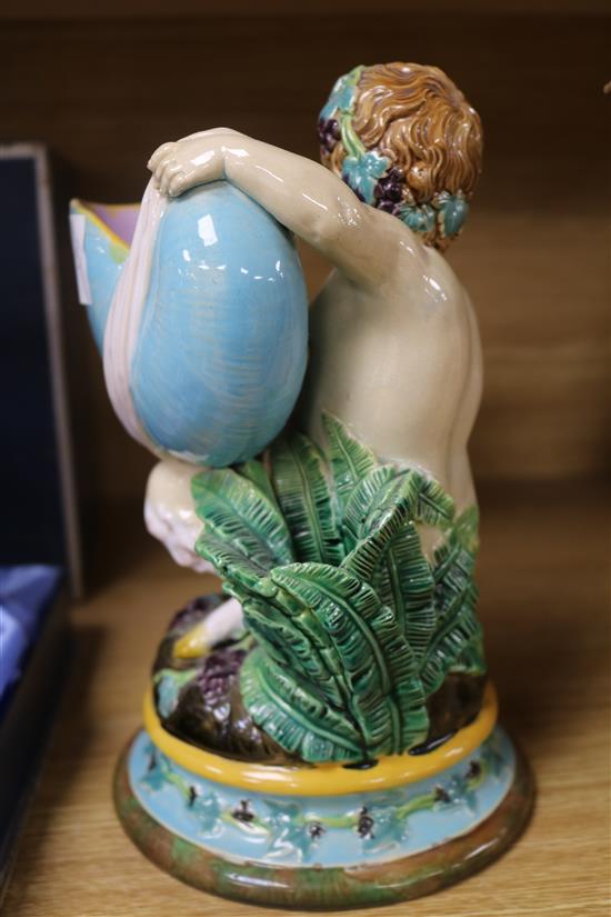 A Victorian majolica model of a faun holding a nautilus shell height 22cm
